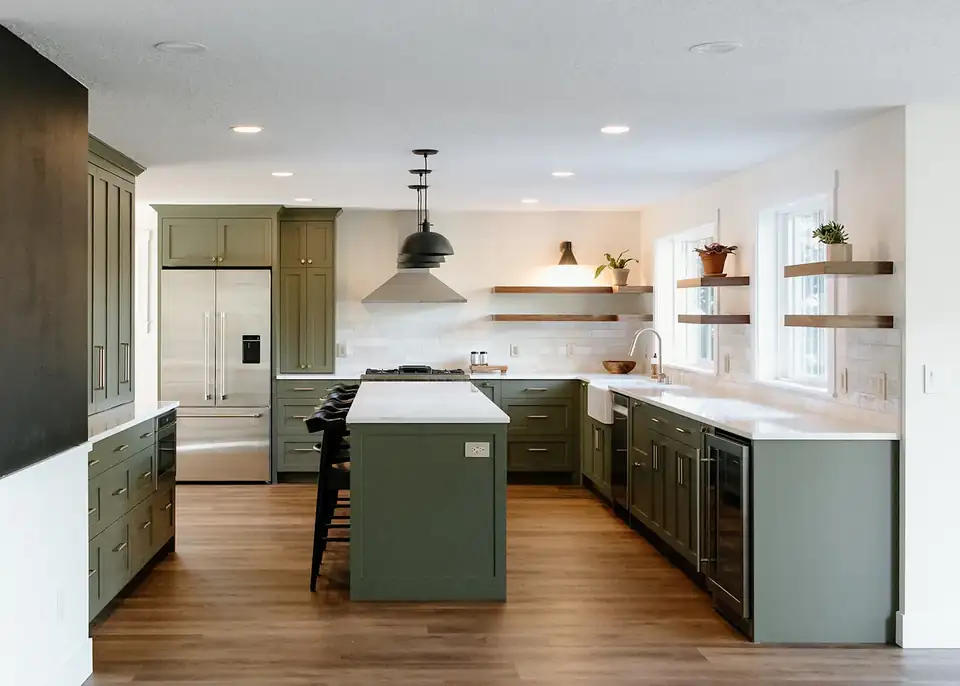Kitchen remodeling Vancouver WA: sage green shaker cabinets, white quartz island, floating wood shelves and wood floors in a 98665 home