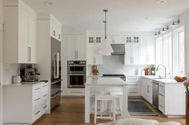 Remodeled kitchen in Vancouver, WA 98685 with white shaker cabinets, white island, subway tile and stainless double wall ovens
